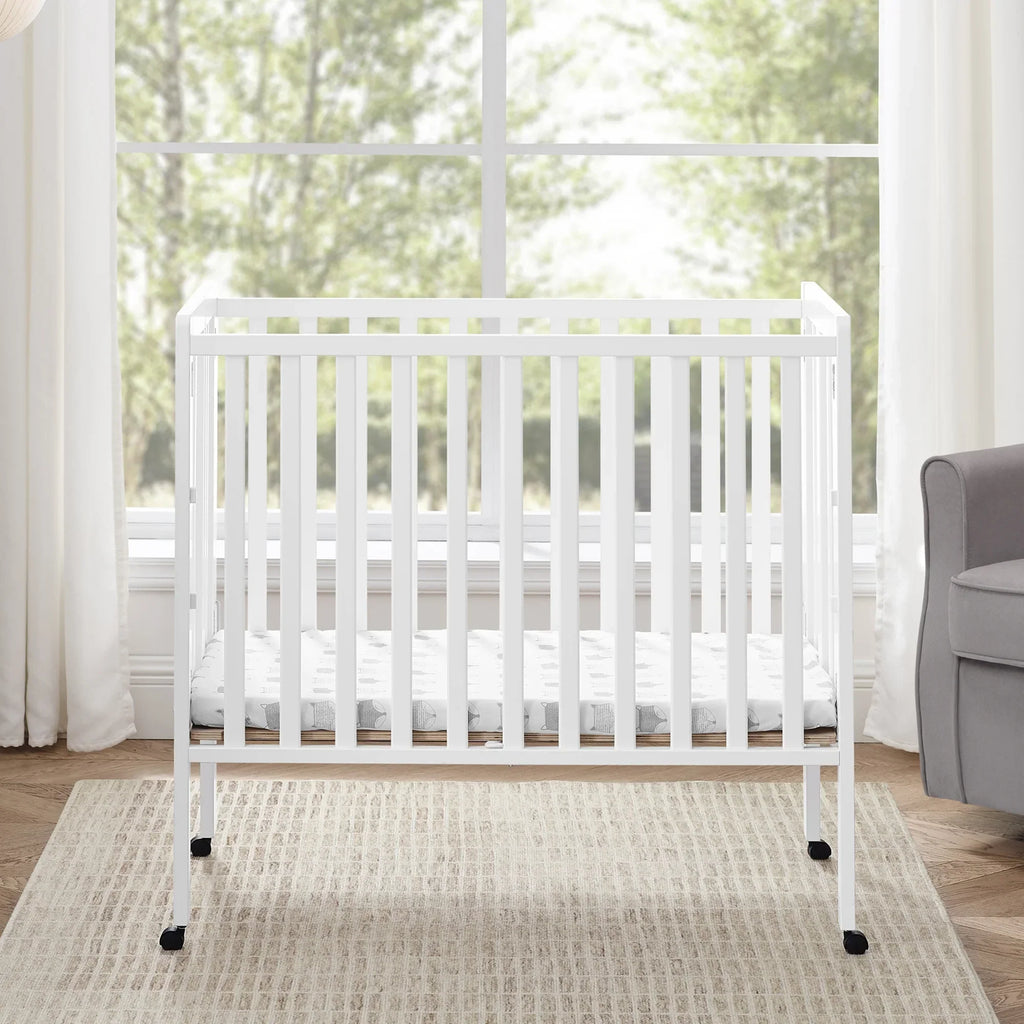 2026 NewDelta Children Lee Portable Folding Mini Crib with 1.5-Inch Mattress - Greenguard Gold Certified, Bianca White
